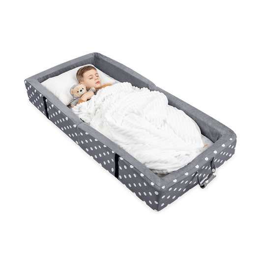 A Toddler Hugging a Teddy Bear While Sleeping on a Gray Milliard Toddler Travel Bed